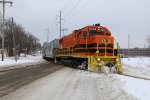 Its orange paint standing out from the snowy and bleak landscape, GR 2104 rolls west on former GTW rails